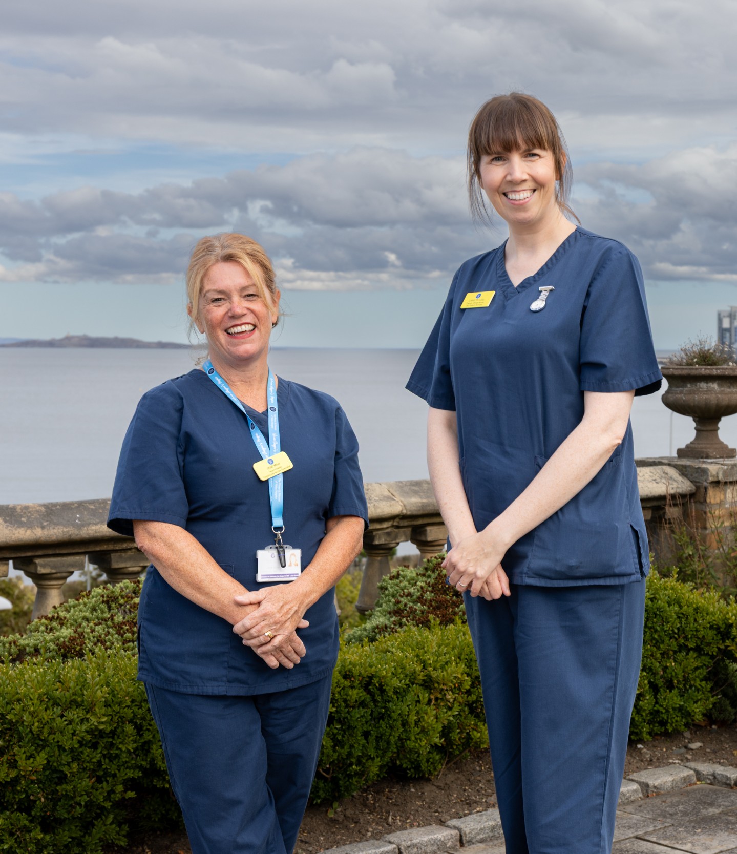 Two smiling hospice nurses